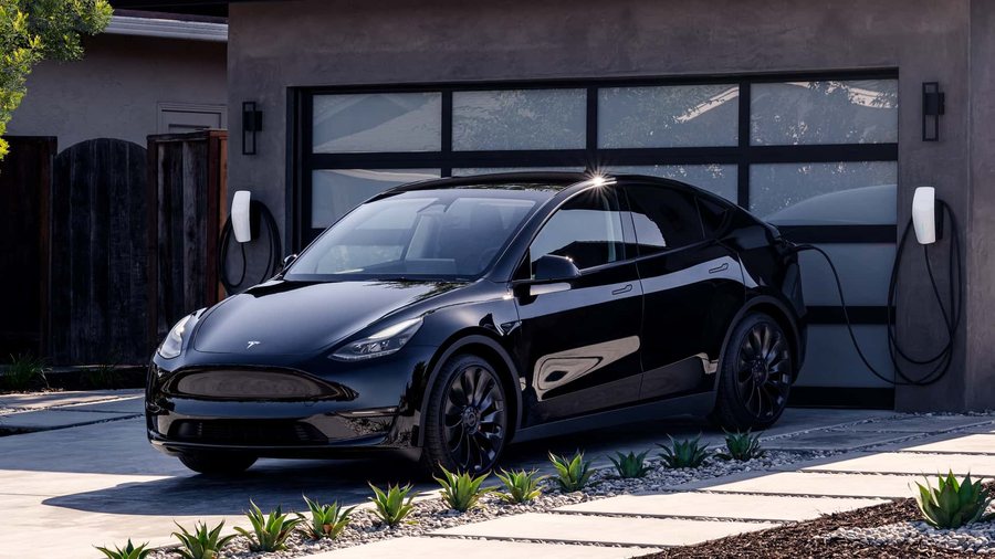 A Solid Black Model Y plugged in at a house